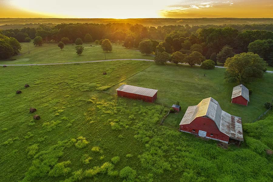 Insurance Quote - View of Farm and Green Fields at Sunset